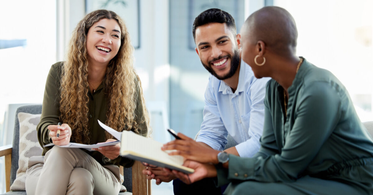 Young colleagues happily discussing their work