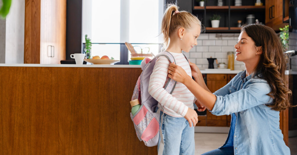 Mother preparing her daughter for school