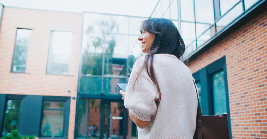Woman looking up at building