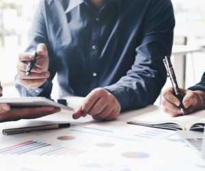 Business people looking at data and numbers